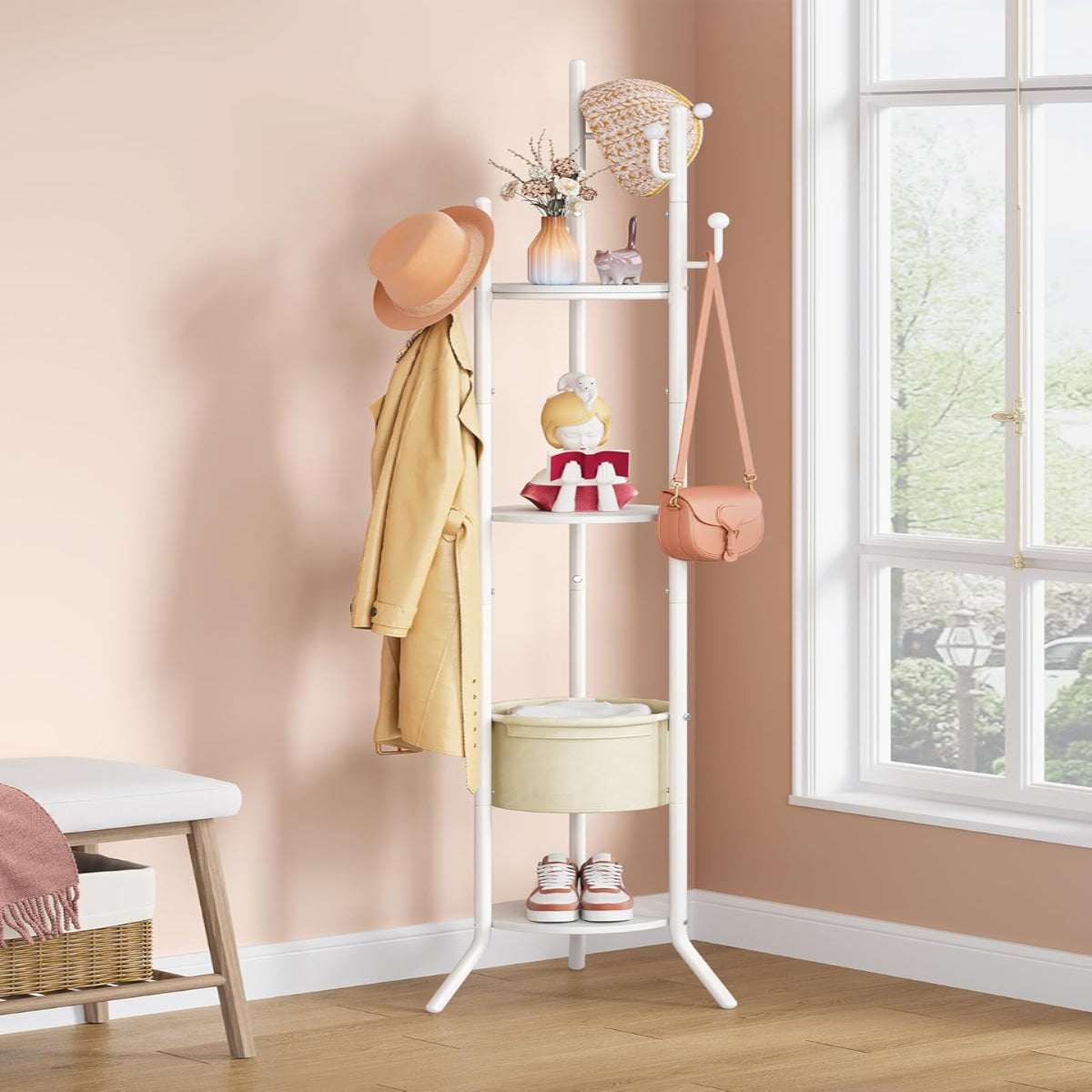 White coat rack with shelves against a beige wall, holding various items.