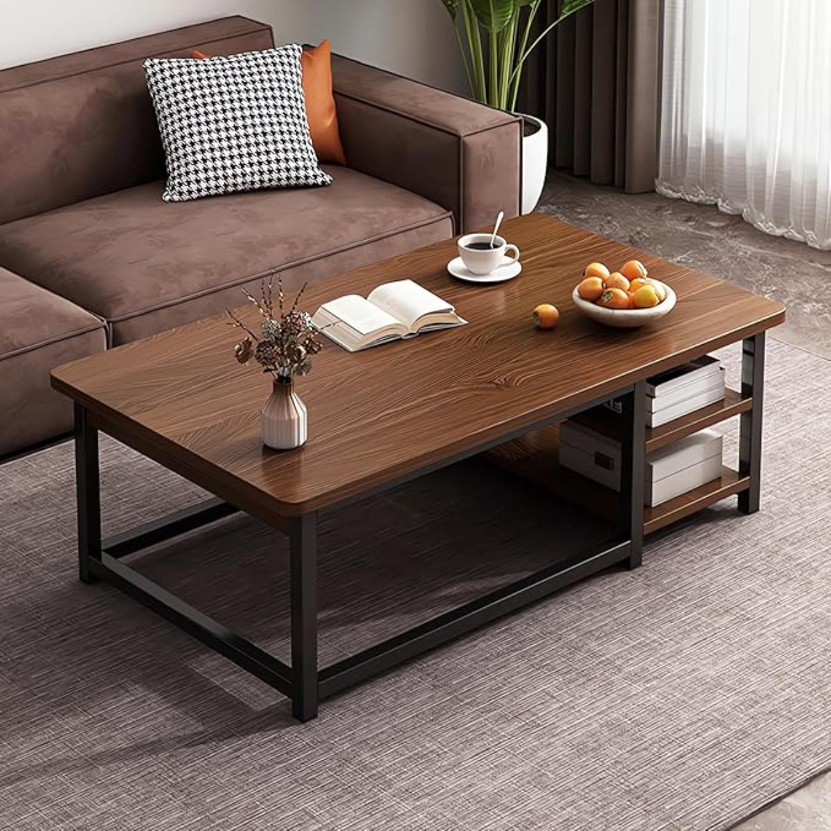Wooden coffee table with a book, cup, and fruit bowl in a living room setting.